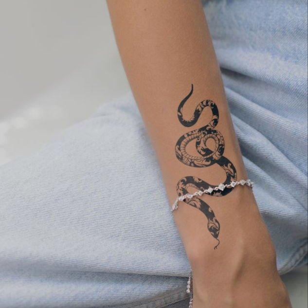 Snake of Wisdom tattoo on hand