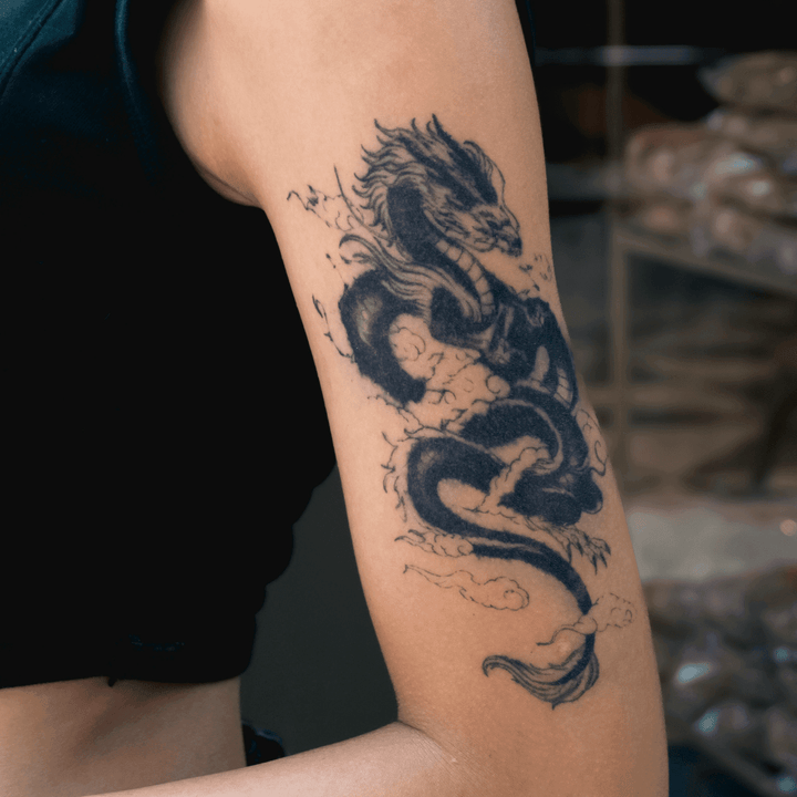 Asian Dragon with Clouds tattoo on arm