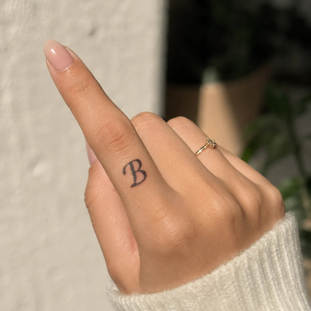 B Letter Tattoo On women hand