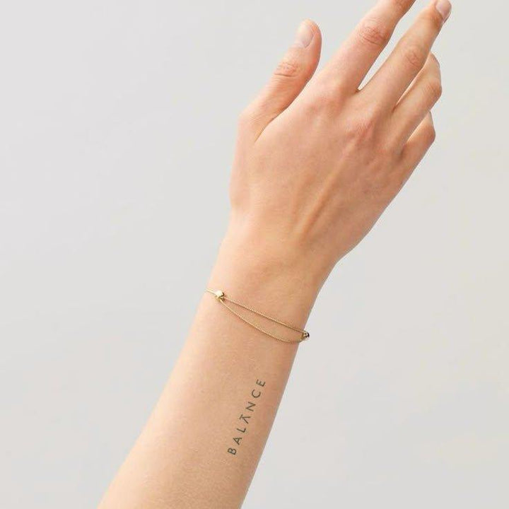 Balance tattoo on arm