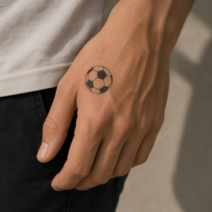 Football tattoo on man hand
