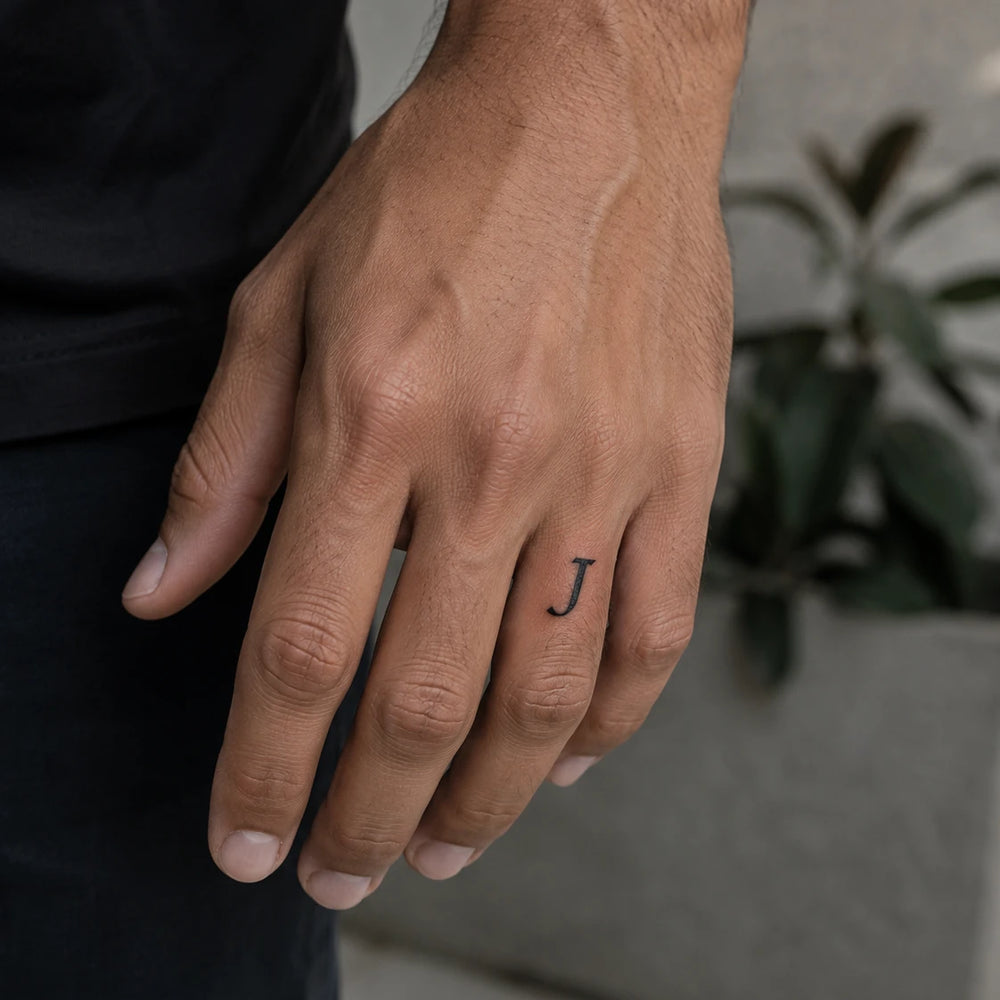 J Letter tattoo on man hand