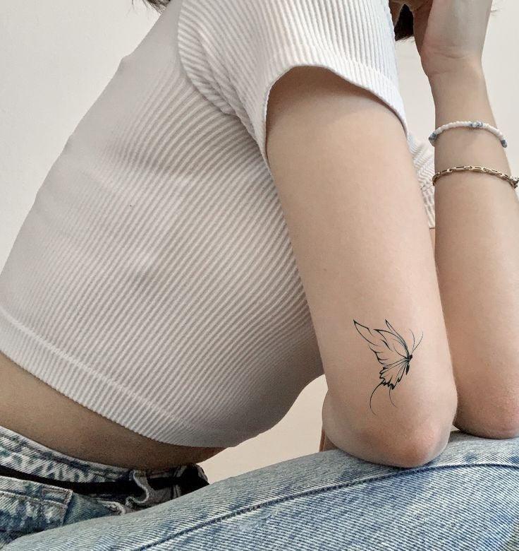 Minimalist Butterfly Tattoo On Arm