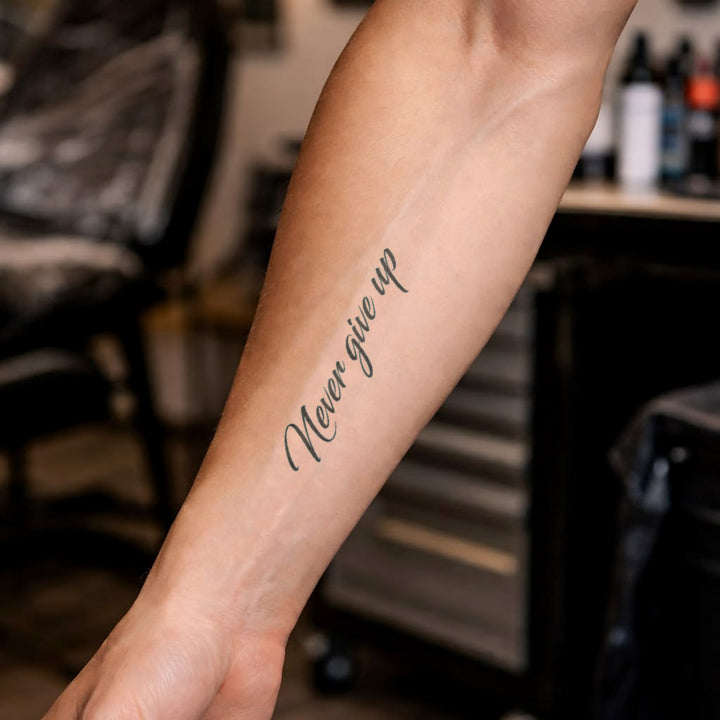 Never Give Up Tattoo on Hand