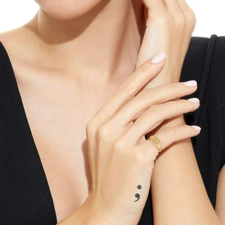 Semicolon tattoo on hand