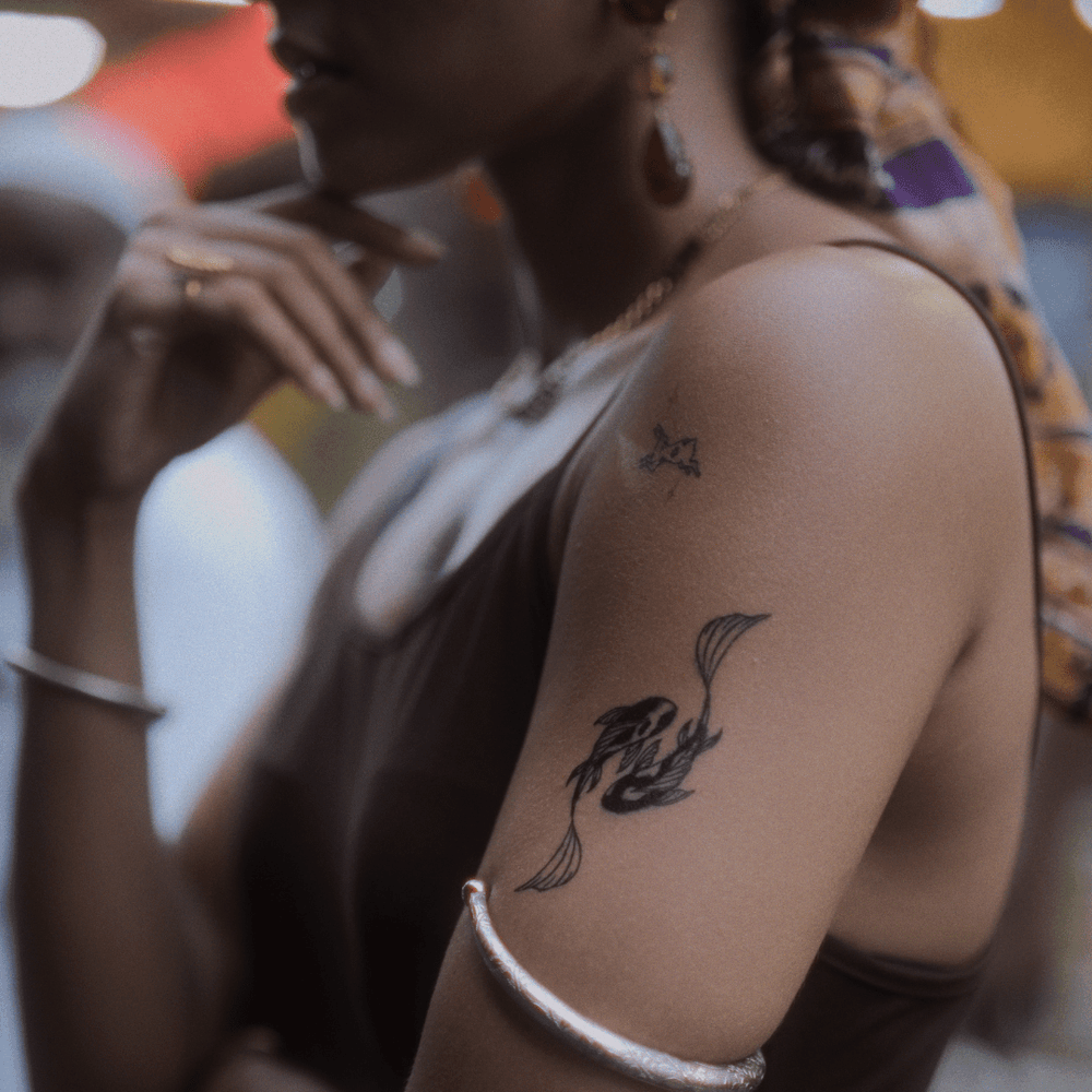 Yin Yang Koi Fish tatto on arm