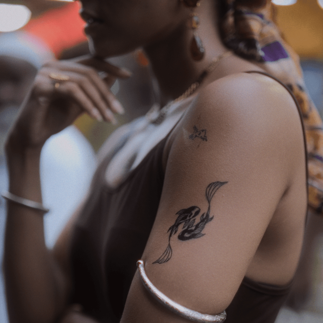 Yin Yang Koi Fish tatto on arm