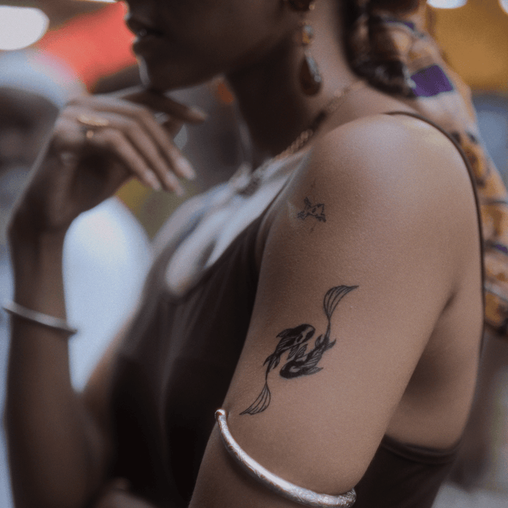 Yin Yang Koi Fish tatto on arm