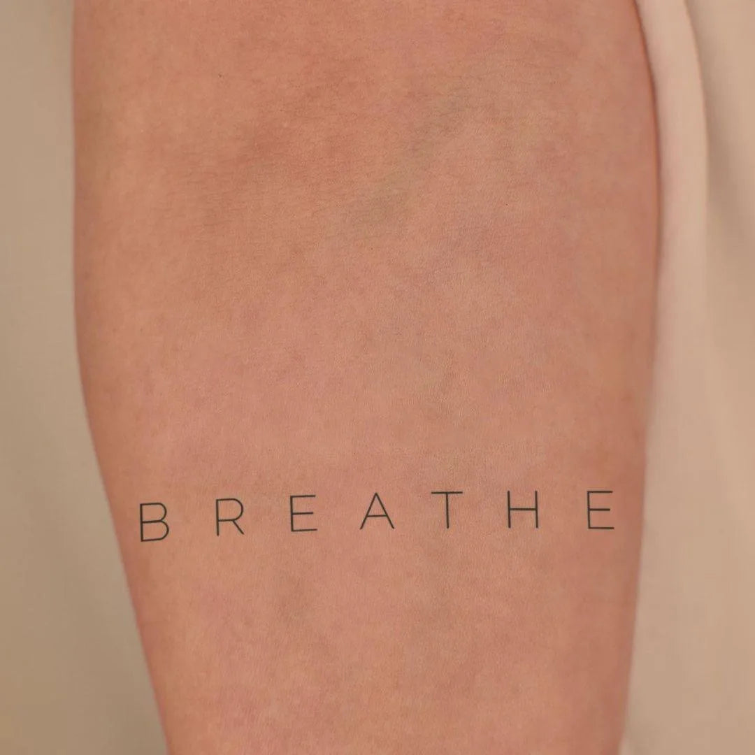Breathe tattoo on hand
