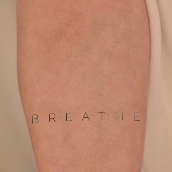Breathe tattoo on hand