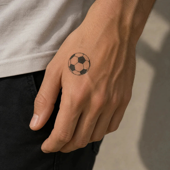 Football tattoo on man hand